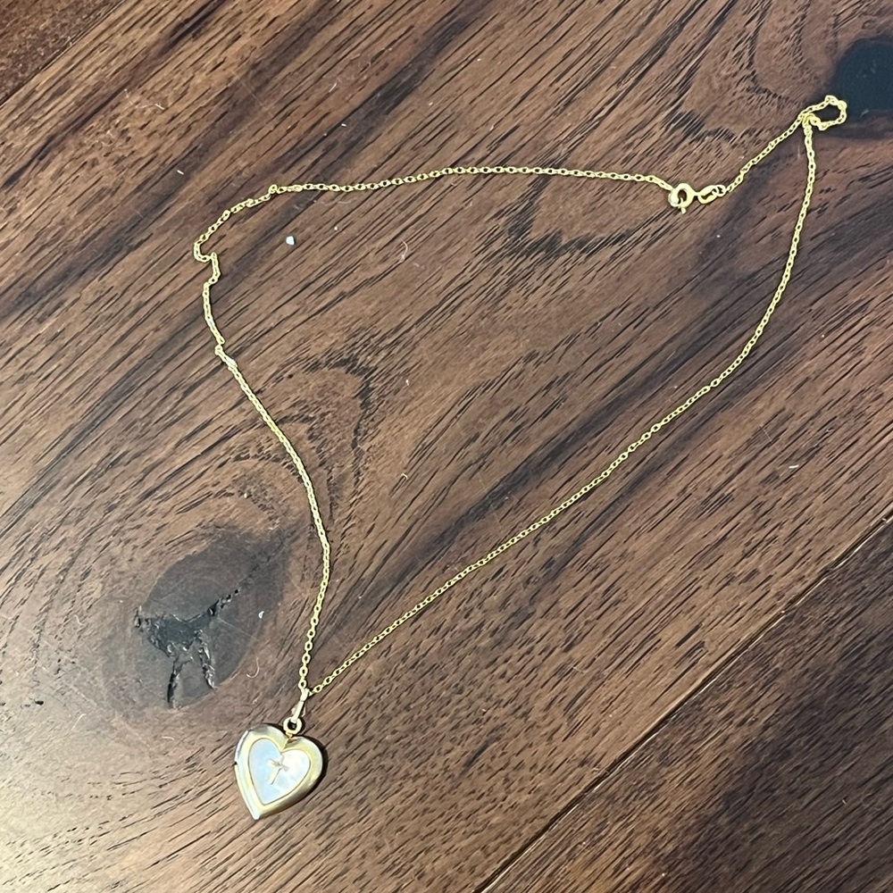 Gold costume necklace with heart shaped pearl cross locket pendant.